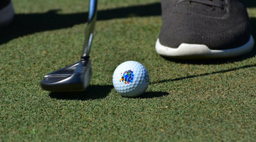 Action image of a Saintnine golf ball being putt into a hole.